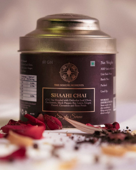 Tea canister labeled 'Shahi Chai' with tea leaves and spices on a blurred background